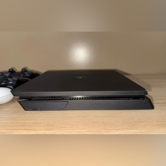 PLAYSTATION 4 Sony Slim Black Console with Three Controllers.